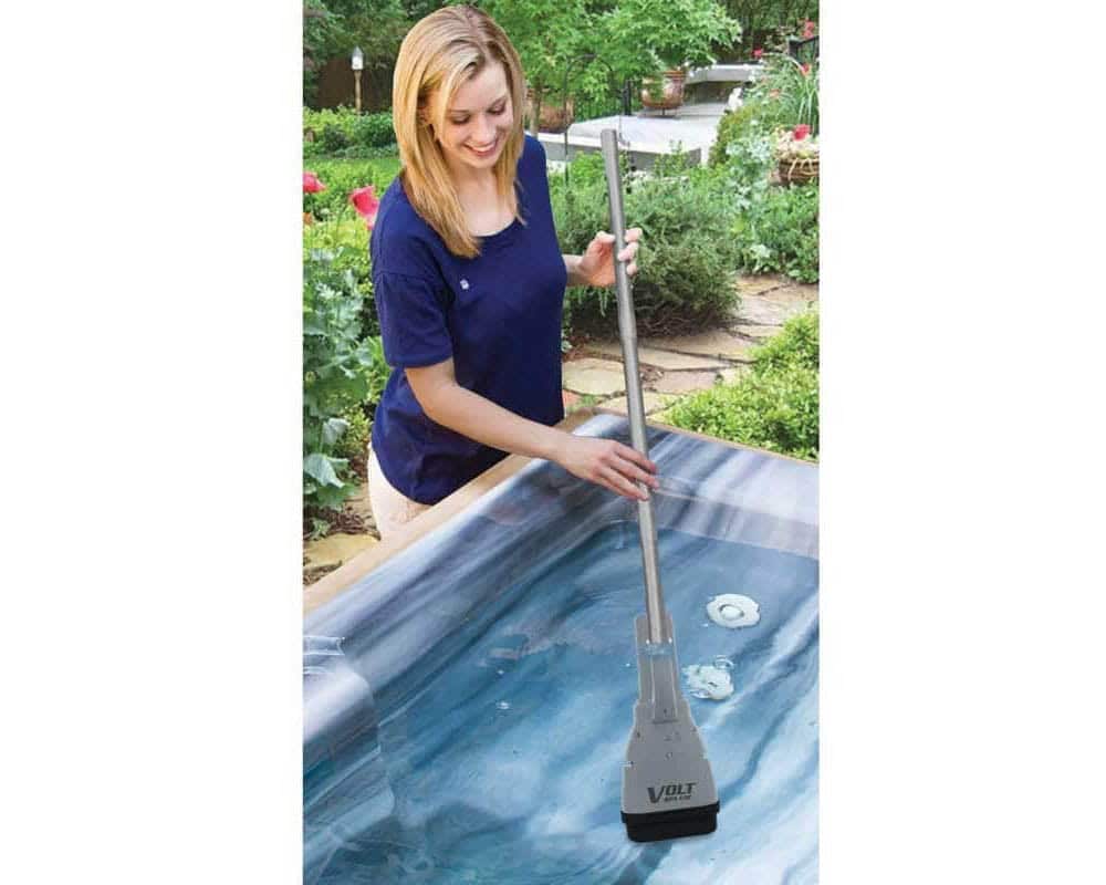 woman is cleaning hot tub with Cordless Spa Vacuum
