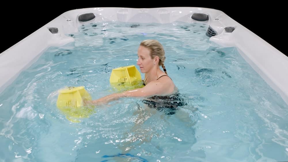 woman is doing fitness in jacuzzi swim spa