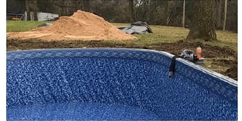 installed pool frame with sand left over