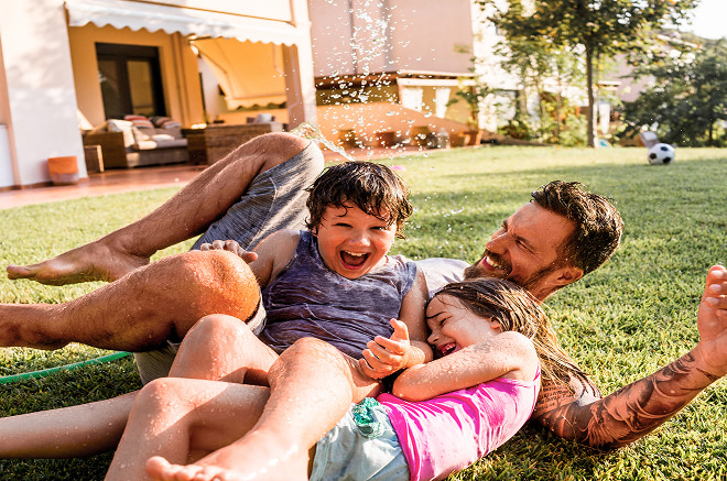 dad and kids playing in yard