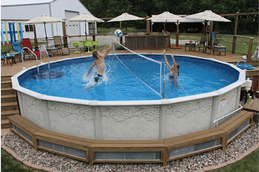 kids playing volleyball in a flat bottom above ground pool
